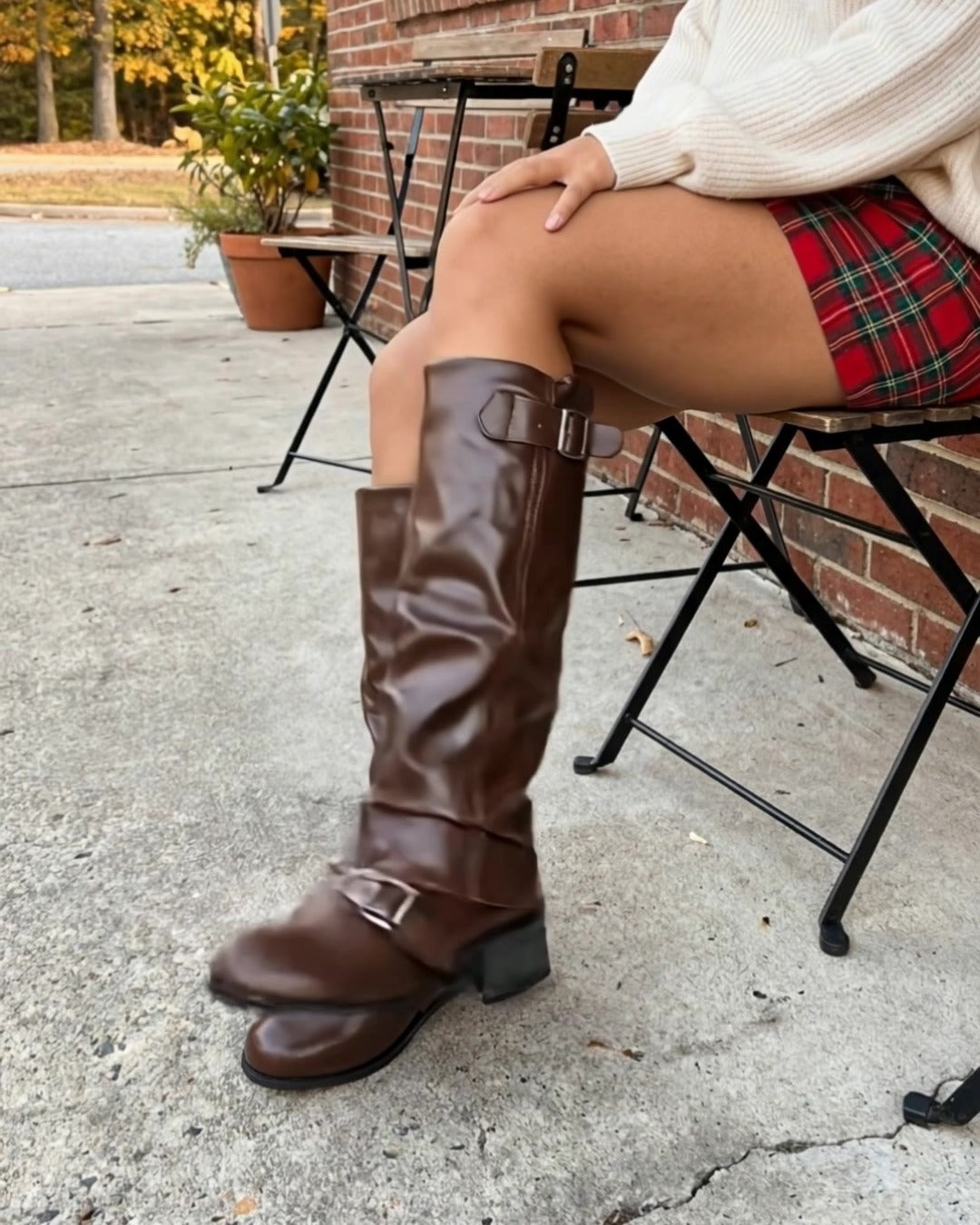 Harlow boots in Brown with a plaid mini skirt and cream sweater